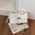 Elegant white quilted crossbody small square bag featuring pearl bow and chain strap. - With Charm / White