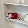Red quilted shoulder bag with elegant pearl lace bow accessory and silver chain - With Charm / Red