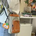 Stylish orange and beige grid bucket crossbody bag with a cute plush mascot charm - With Charm Style / Gray and Orange