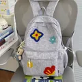 Detailed view of a grey student backpack with cute plush flower patches and bear charm - With Charm / Dark Gray