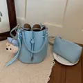 Elegant light blue pebble leather bucket bag with cute bear charm and matching pouch - With Charm / Blue