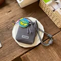 Detailed macro view of a grey mesh drawstring bucket bag featuring a banana patch - With Charm / Gray
