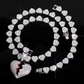Detailed view of iced-out broken heart pendant and heart-link chain necklace set - Heart Pendant Necklace And Bracelet Set / Silver