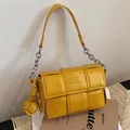 Yellow padded woven leather underarm bag with silver chain strap for women - Yellow