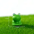 Macro view of a miniature green resin frog with 1.7cm height and 1.5cm width - Frog
