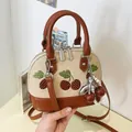 Elegante bolso de hombro beige con cerezas bordadas y un colgante de cereza y perla - Con Colgante / Caqui
