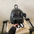 Fashionable small black patent leather backpack for women with a stylish bow detail - With Charm Style / Black With Pendant
