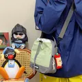 Bolso bandolera deportivo verde y gris claro para hombres y mujeres en escena casual al aire libre - Con Colgante / Verde