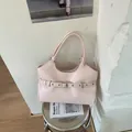 Detail view of pink glossy tote bag with decorative belt buckle detail - Pink