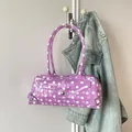Stylish purple polka dot PVC transparent baguette shoulder bag hanging on a wall hook - Purple