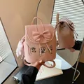 Close-up view of the bow and puppy embroidery details on the pink sweet backpack - With Pendant / Pink