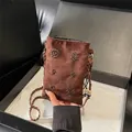 Brown suede crossbody phone bag featuring decorative beadwork and braided leather strap - Brown