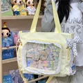 Pale yellow ita bag with lace trim and anime badges display - With Charm / Yellow