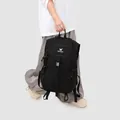 Large capacity black outdoor hiking backpack shown being carried by a walking model - Obsidian Black
