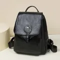Detailed view of fashionable black leather women's backpack with kangaroo logo - Black