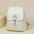 Detail view of a cream-white leather backpack featuring a decorative kangaroo logo buckle. - Off White
