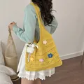 Handmade yellow crochet tote bag featuring vibrant flower appliques and white fluffy charm - Yellow with Pendant