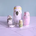 Close-up detail of five handcrafted bird-themed wooden nesting dolls on marble surface - Cartoon Bird Style (TW-SG0508) / 5-Piece Nesting