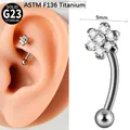 Close-up detail of 5mm flower zircon G23 titanium curved barbell eyebrow piercing - #5-10mm