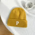 Detailed macro view of a vibrant yellow knit beanie featuring a white embroidered letter P - 55-59cm (Elastic) / Yellow