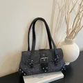A close-up view of the vintage grey patterned baguette bag with silver studs and buckle - Black