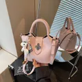 Elegant pink bucket style handbag for women featuring a crossbody strap and a cute white horse charm - Pink (With Pendant)