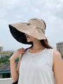 Stylish beige wide-brim sun hat with black vinyl lining worn by a woman for sun protection - 55-58cm / Khaki
