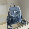 Retro vintage style blue denim backpack with ruffle lace trim and decorative front pockets - Blue