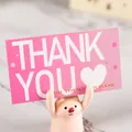 Detailed view of a pink thank you for your purchase card held by a cute piglet figurine - Pink Heart (80300)