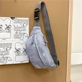 Detailed macro view of the trendy grey star pattern sporty casual waist bag on a corkboard - Gray