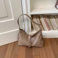 Vintage style tan faux leather underarm shoulder bag with adjustable strap and buckle - Brown