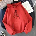 Detailed shot of red fleece hoodie featuring a black finger heart graphic design. - S / Tops / Finger Heart Red