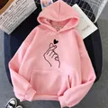 Detail of pink fleece hoodie featuring a black finger heart graphic on the chest. - S / Tops / Finger Heart Dusty Pink
