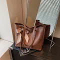 Stylish brown geometric embossed faux leather tote bag with elegant silk scarf accessory - Brown