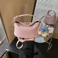 Pink pebbled leather bucket handbag with cute teddy bear charm for women. - Style With Pendant / Pink