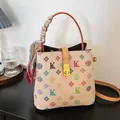 Vintage printed bucket bag with colorful motifs and silk scarf handle detail - Multicolor