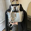 Stylish light blue denim bucket bag with silver star charm and rhinestone detail - With Star Charm / Light Denim Blue