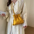 Vibrant yellow drawstring bucket crossbody bag with stylish pebbled leather texture - Yellow