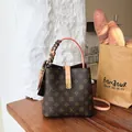 Elegant vintage monogram bucket bag featuring a silk scarf wrapped handle and gold lock - Coffee And Apricot