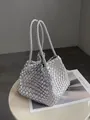 Close-up of silver woven bucket bag with intricate handmade texture on minimalist table. - With Small Pouch / Silver