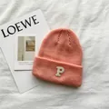 Detailed view of soft peach knitted beanie featuring white embroidered letter P on fold - 55-59cm (Elastic) / Pink