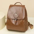 Stylish brown textured leather backpack for women featuring a kangaroo logo design. - Brown