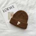 Macro view of a cozy brown knitted beanie featuring high-quality white letter P embroidery - 55-59cm (Elastic) / Brown