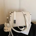 Elegant off-white canvas and leather crossbody pillow bag for women with cute bear charm - With Charm / Off White