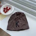 Brown slouchy beanie hat for women featuring a black embroidered K letter detail - 56-59cm / Coffee