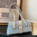 Stylish light blue denim baguette underarm bag featuring silver buckle and Y2K studded details - Light Blue