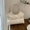 Stylish creamy white faux leather tote bag with buckle strap detail and silver hardware - White