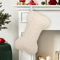 Bone-shaped knitted Christmas stocking in cream white hanging on fireplace for holiday decor - Diamond Knit Stocking / White