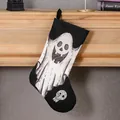 Decorative Halloween stocking featuring a white ghost and skull print on black fabric - Ghost