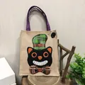 Halloween burlap gift bag featuring a cute black cat with a green plaid hat and bow tie. - Black Cat Style